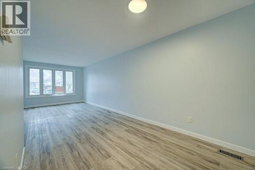 Spare room featuring light wood-style flooring and baseboards - 310 Magnolia Drive, Hamilton, ON 
