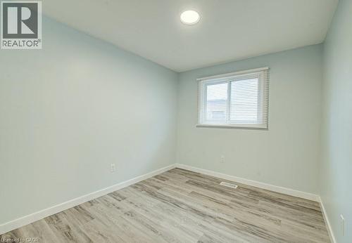 Spare room with baseboards and light wood-style flooring - 310 Magnolia Drive, Hamilton, ON 
