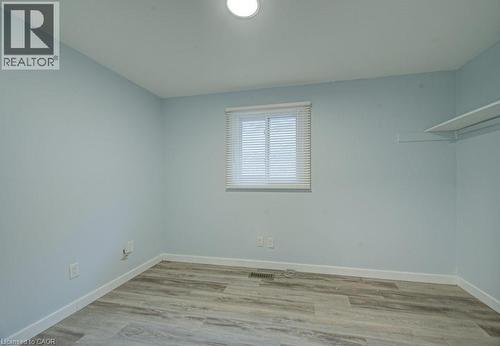 Unfurnished room with light wood-type flooring and baseboards - 310 Magnolia Drive, Hamilton, ON 