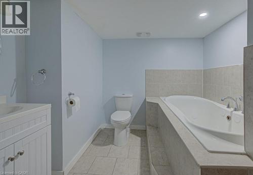 Full bathroom featuring vanity, a garden tub, light tile patterned floors, and recessed lighting - 310 Magnolia Drive, Hamilton, ON 