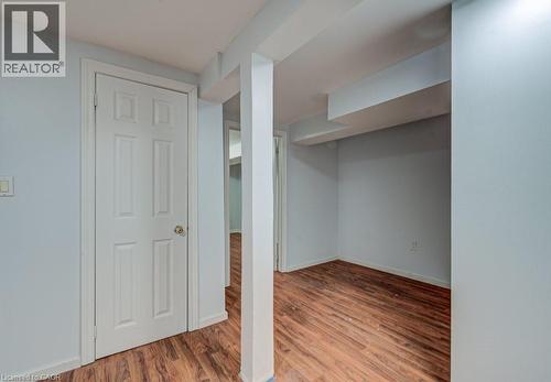 Finished below grade area with light wood finished floors and baseboards - 310 Magnolia Drive, Hamilton, ON 