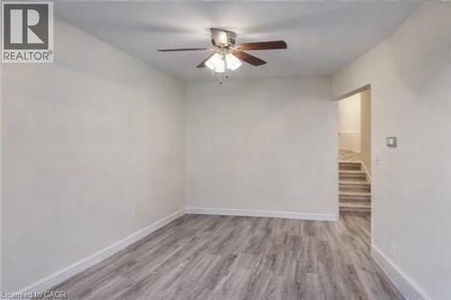Spare room with light wood-type flooring and a ceiling fan - 310 Magnolia Drive, Hamilton, ON - Indoor Photo Showing Other Room