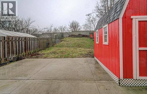 Fenced backyard featuring a patio area and an outdoor structure - 310 Magnolia Drive, Hamilton, ON 