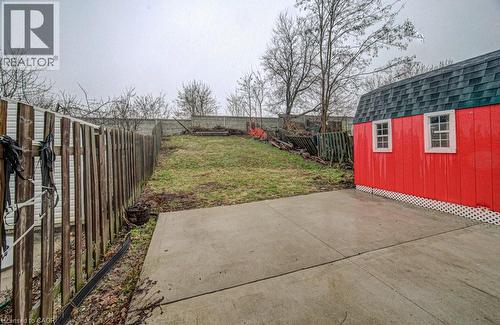 Fenced backyard with a patio and a storage shed - 310 Magnolia Drive, Hamilton, ON 