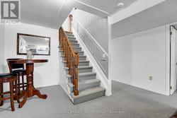STAIRCASE TO LOWER LEVEL FAMILY ROOM AND BEDROOMS - 