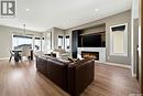 13 Plains Green, Pilot Butte, SK  - Indoor Photo Showing Living Room With Fireplace 