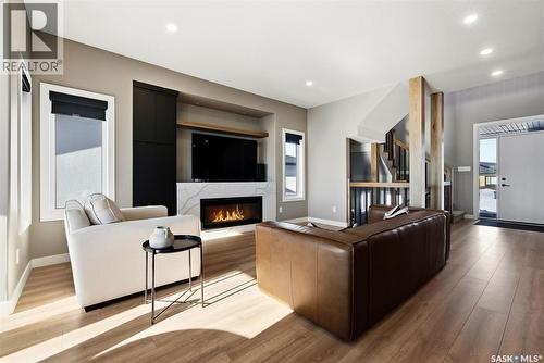 13 Plains Green, Pilot Butte, SK - Indoor Photo Showing Living Room With Fireplace