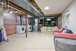 Unfinished basement with laundry area. - 