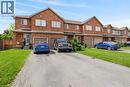 This property features a brick exterior with white-framed windows and an attached garage with a brown door - 10 Cadham Boulevard Unit# 29, Hamilton, ON  - Outdoor With Facade 