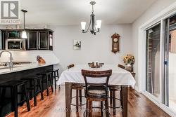 dining area with sliders to a 3 season sunroom - 