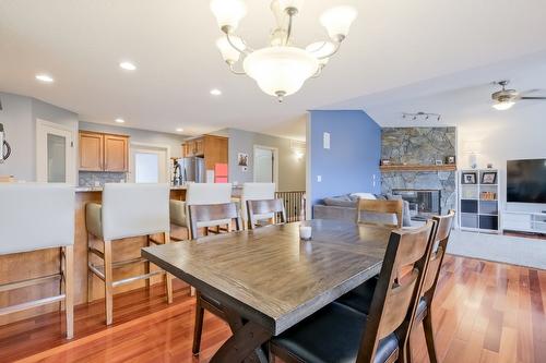 1410 Kendra Court, Kelowna, BC - Indoor Photo Showing Dining Room With Fireplace