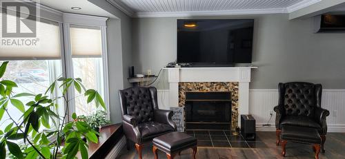 Wood burning fireplace - 15 Squires Road, Eastport, NL - Indoor With Fireplace