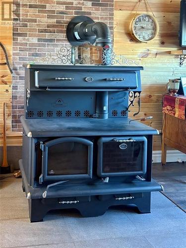A fantastic wood stove for cooking and heat - 15 Squires Road, Eastport, NL -  Photo Showing Other Room