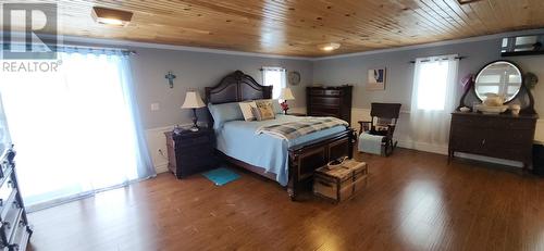 Primary bedroom  with patio door. - 15 Squires Road, Eastport, NL - Indoor Photo Showing Bedroom