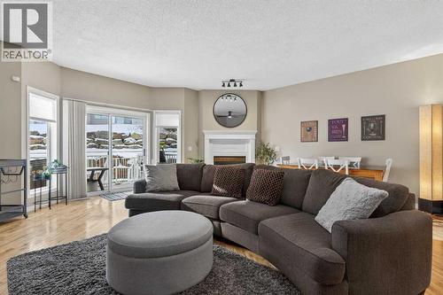 42 Hamptons Link Nw, Calgary, AB - Indoor Photo Showing Living Room With Fireplace