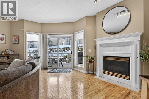 42 Hamptons Link Nw, Calgary, AB - Indoor Photo Showing Living Room With Fireplace