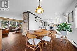 Open dining area positioned between the kitchen and living room, offering excellent flow for hosting. Ample space for a full dining table and easy access to outdoor entertaining areas. - 