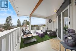 Large rear deck with gas outlet, ideal for barbecuing and outdoor entertaining, overlooking the backyard and pool area. - 