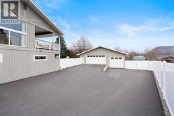 Tons of parking on the paved driveway, plus gated RV parking and a large drive through shop. - 