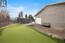 Backyard features a private putting green, ideal for practice and entertaining. - 