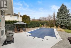 Fully landscaped and private backyard designed for lifestyle and entertaining. Features include a heated in ground pool with, putting green, golf net, and ample patio space. - 