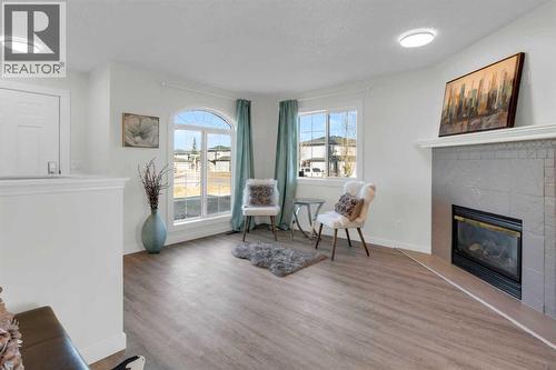 103 Canoe Square Sw, Airdrie, AB - Indoor Photo Showing Living Room With Fireplace