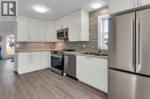 103 Canoe Square Sw, Airdrie, AB - Indoor Photo Showing Kitchen With Double Sink With Upgraded Kitchen