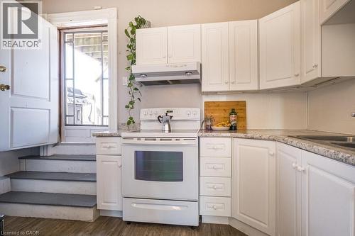 Walk-out to a large private deck from the kitchen. 10x15.8 sq. ft. (161 square ft.) - 270 Queen Street S Unit# 2, Hamilton, ON - Indoor Photo Showing Kitchen