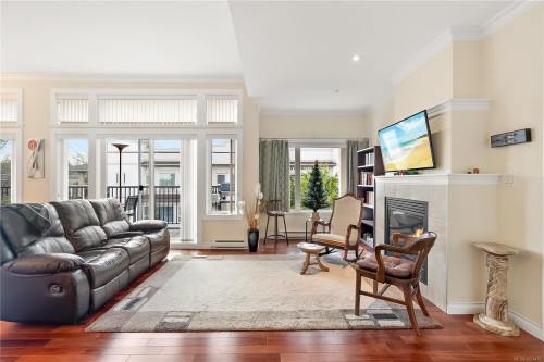 303-9942 Third St, Sidney, BC - Indoor Photo Showing Living Room With Fireplace