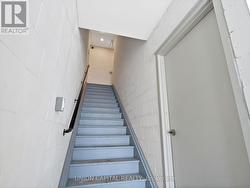 STAIRCASE TO UPPER LEVELS & BASEMENT ENTRY DOOR - 