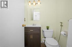 Half bath featuring vanity and toilet - 