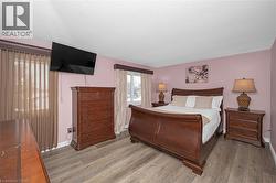 Bedroom with wood finished floors and baseboards - 