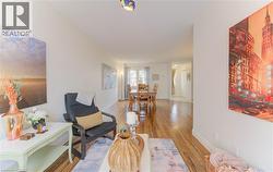 Sitting room featuring baseboards and wood finished floors - 