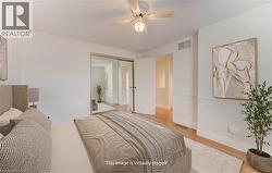 Bedroom featuring ceiling fan, light wood-type flooring, and a closet - 