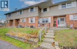 View of front of home with brick siding and a front yard - 