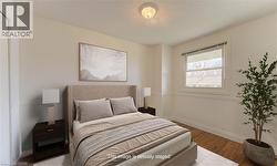 Bedroom featuring wood finished floors and a textured ceiling - 