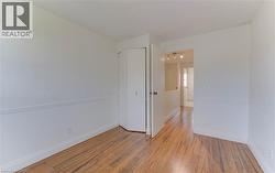 Spare room with light wood-style flooring and baseboards - 