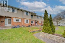View of front facade with brick siding and a front yard - 