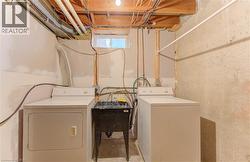 Washroom with independent washer and dryer and concrete flooring - 