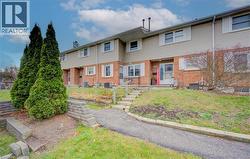 View of front of home featuring brick siding and a front yard - 