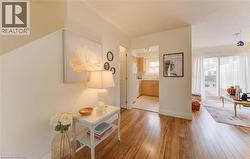 Corridor with light wood-style flooring and baseboards - 