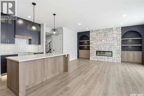 166 Cockroft Manor, Saskatoon, SK - Indoor Photo Showing Kitchen With Fireplace With Upgraded Kitchen