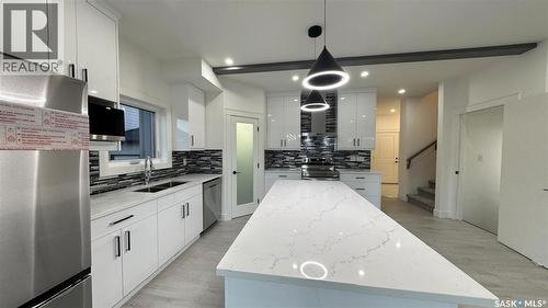 147 Woolf Bend, Saskatoon, SK - Indoor Photo Showing Kitchen With Double Sink