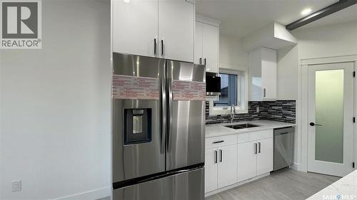 147 Woolf Bend, Saskatoon, SK - Indoor Photo Showing Kitchen With Stainless Steel Kitchen With Double Sink