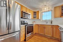 Updated kitchen with stainless steel appliances and quartz countertops - 