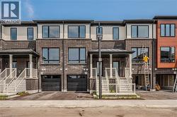 Modern home with asphalt driveway, brick siding, and a garage - 