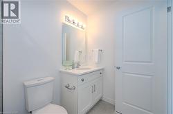 Half bath featuring vanity and light tile patterned floors - 