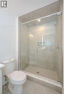 Full bathroom featuring a stall shower, vanity, and tile patterned floors - 