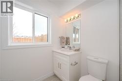 Full bath with vanity, plenty of natural light, light tile patterned flooring, and a shower - 
