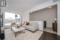 Living room with light wood-style flooring and recessed lighting - 